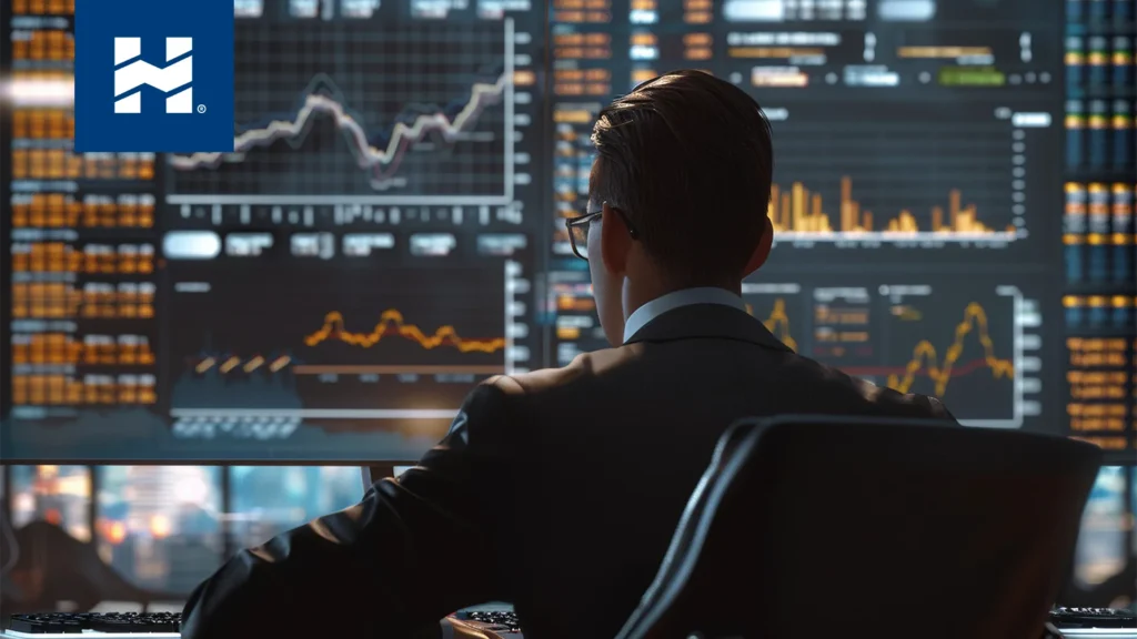 Bróker trading; hombre sentado revisando el rendimiento de las inversiones de sus clientes