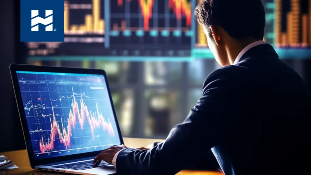 Qué es el trading; hombre frente a una computadora revisando la bolsa de valores
